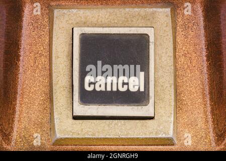 Retro styled image of a cancel push button on a vintage arcade game machine Stock Photo