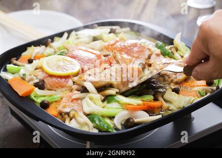 Japanese cooking; Hokkaido style salmon chanchan yaki, stir fried salmon and vegetables, seasoned with miso sauce. Stock Photo