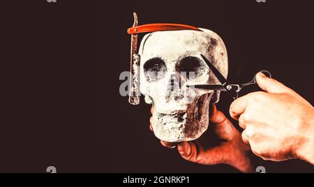 Skull barber. Vintage barber shop tools. Barber scissors and straight razor, barber shop. Still life skull with shaving tools. Barber shop tool on Stock Photo