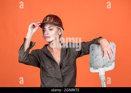 a bit tired. building and construction. lady architect worker. engineer on orange background. Stock Photo