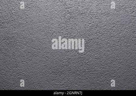 Grey matte stone wall texture. Uneven surface painted in gray colour. Backdrop with irregularities and relief. Horizontal photo. Stock Photo