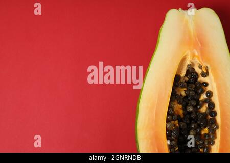 Half of ripe papaya on red background Stock Photo