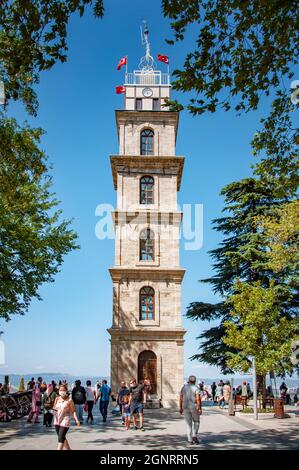 BURSA, TURKEY. AUGUST 15, 2021. Old tower on the square. People walking around Stock Photo