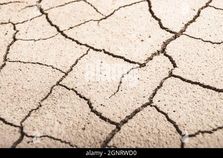 Close shot cracked dry earth. For water crisis, drought in UK, parched earth, crop loss, European or US heatwave, hot summer season, aridification. Stock Photo