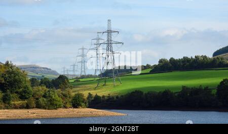 Electricity Pylons in the Peak District National Park close to Bottoms Reservoir  and Hadfield Derbyshire. Stock Photo