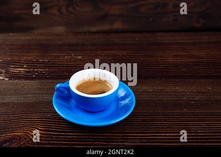 Dirty blue cup after coffee on a wooden table.  Stock Photo