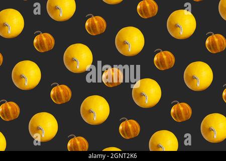 Pumpkins Seamless Pattern on Dark background, top view, Autumn Holiday Concept. Stock Photo