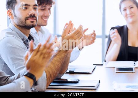 Closeup of businesspersons clapping hands and applauding in business meeting conference. While female business executive sitting in front - selective focus - woman power in corporate work Stock Photo