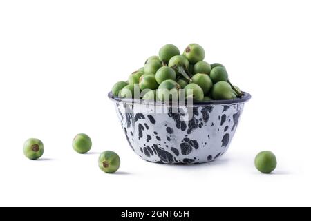 turkey berry, also called wild eggplant or pea eggplant, cup full of round vegetable isolated on white background Stock Photo