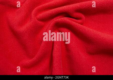red fabric texture background lying in the shape of a wave, with copy space Stock Photo
