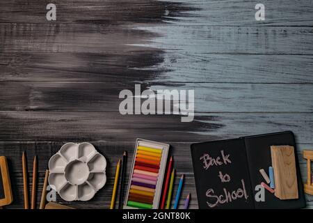 School supplies on black board background. Back to school concept. Stock Photo