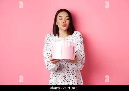 Young Asian smiling and lips giving passionate kiss Stock Photo