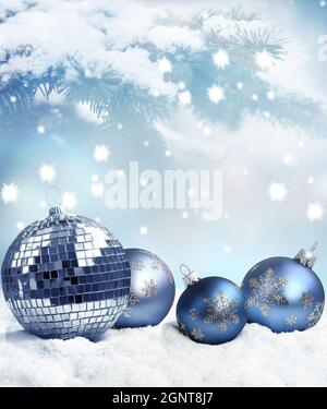 Beautiful blue Christmas balls on snow and winter background. Stock Photo