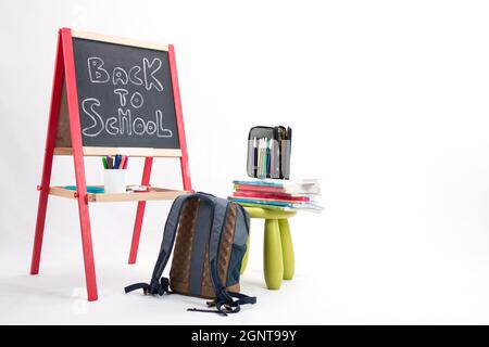 Back to school background - chalkboard, backpack and school items isolated on white background Stock Photo