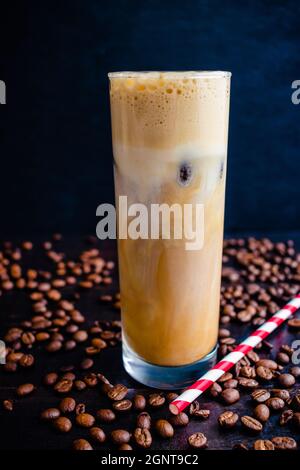 Iced Irish Coffee with Coffee Ice Cubes and Paper Straws: Tall glass of iced coffee made with Irish whiskey and coffee ice cubes Stock Photo