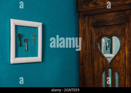 Key in frame on blue wall backgroung. Key new home, homeownership, keys to the house, buying home. Stock Photo