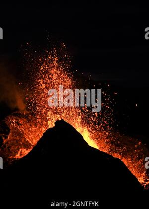 Eruption at Fagradalsfjall, Iceland. Incandescent lava is erupted from the volcanic vent. Taken at night, the lava is isolated on a black background. Stock Photo