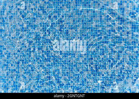Swimming pool mosaic bottom caustics ripple like sea water and flow with waves background with sun light reflection, sport and relax concept Stock Photo