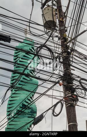 PANAMA CITY, PANAMA - MAY 30, 2016: F&F Tower skyscraper in Panama City viewed through a chaos of wires Stock Photo