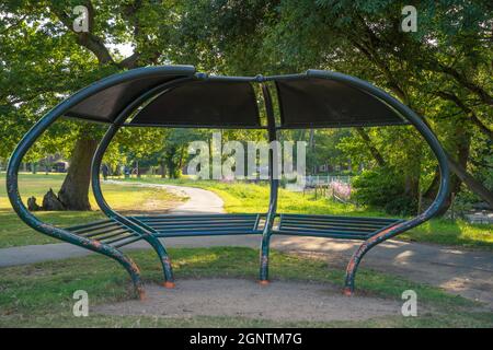 St Helens Church . Boultham Park Lincoln, Boultham Park, Lincoln, Lincolnshire, seating, shelter, area, park bench, picnic shelter, woodland, metal. Stock Photo