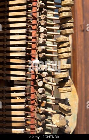 piano tuning pegs and hammers in bright sunshine. Inside parts of wooden musical instrument. Vintage harpsichord detail. Background and wallpaper Stock Photo