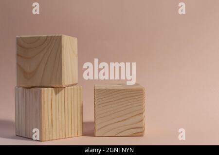 wooden cubes still life against pale pink background Stock Photo