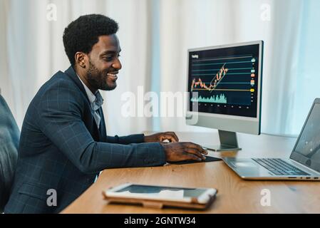 Black man working with binary option Stock Photo