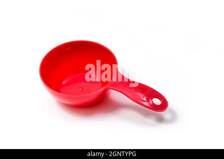Red ingredient measuring scoop or spoon - half size. Isolated on white background with Clipping path Stock Photo