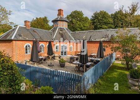 Hønshuset (Royal Hen House). While the Tranekær Castle is in private use, outbuildings such as the chicken house and horse stable have been converted into accommodation and restaurant. Langeland, Denmark Stock Photo
