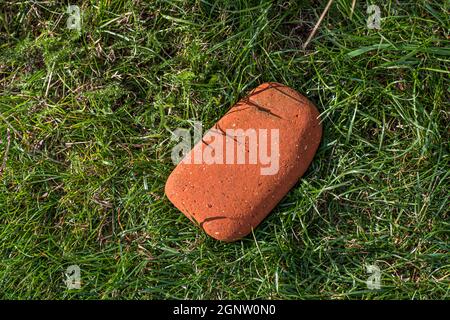 Brick ground down by the ravages of time. Such remains indicate an old brickyard that processed the mineral resources on this part of the Danish island of Langeland Stock Photo