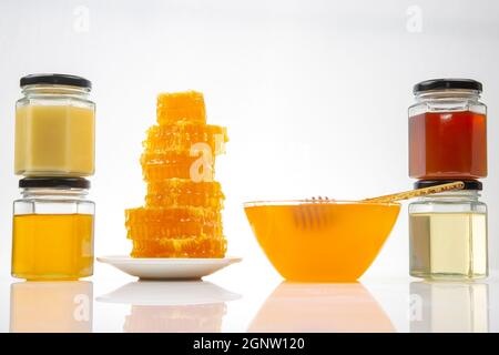 Fresh flower honey of different varieties and honeycomb with spoons on a wooden background. Organic Vitamin Health Food Stock Photo