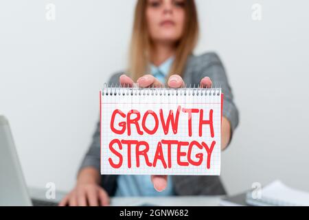 Conceptual caption Growth Strategy. Word for The method a company uses to expand its business or market Financial Advisor Giving Money Saving Tips Stock Photo