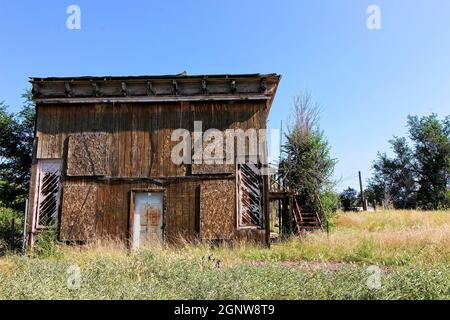 Old Uninhabitable House With Boarded Up Windows Stock Photo