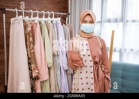 Coronavirus. Asian woman putting on a medical disposable mask to avoid viruses. Stock Photo
