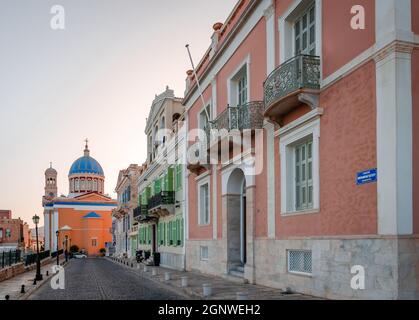 Old neoclassical mansions in Vaporia neighbourhood. in Ermoupolis, the capital of Syros Island. The church of St Nicholas is in the background. Stock Photo