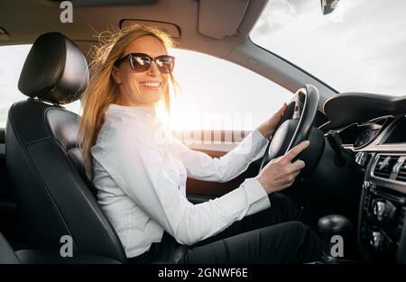 Happy business lady driving car Stock Photo
