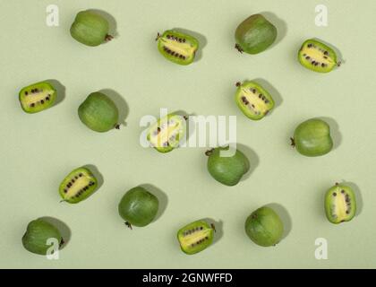 Fruit of actinidia arguta, kiwi berry fruits on green background. Stock Photo