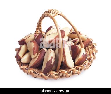 Brazil nuts in small wicker basket on white background Stock Photo