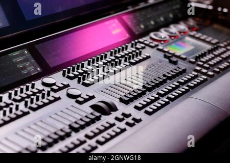 Keys, faders, encoders, and screens on the lighting control console. Selective focus. Stock Photo
