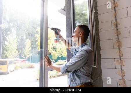 Male worker installing window in flat, closeup Stock Photo