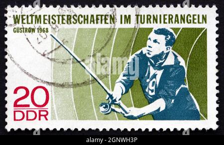 GDR - CIRCA 1968: a stamp printed in GDR shows Angler, World Angling Championships, Gustrow, circa 1968 Stock Photo