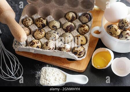 quail and chicken eggs close-up, flour, rolling pin, baking dish Stock Photo