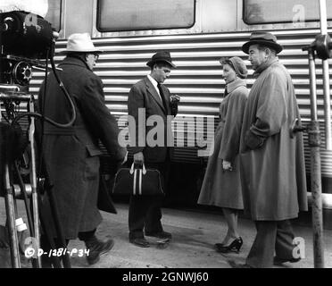 Director FRITZ LANG with GLENN FORD GLORIA GRAHAME and BRODERICK CRAWFORD on set location candid during filming of HUMAN DESIRE 1954 director FRITZ LANG based on novel by Emile Zola screenplay Alfred Hayes gowns Jean Louis Columbia Pictures Stock Photo