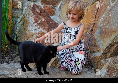 Portrait of little girl (6 years old) with cat, Karlsbad, Czech Republic, Stock Photo