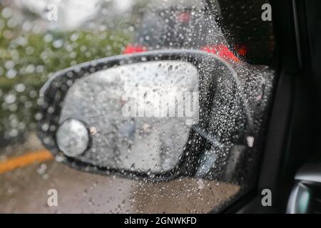 Raindrops on windshield from inside the car in traffic jam Stock Photo