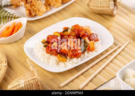 Chinese cuisine, chicken with zucchini deep fried in sour-sweet sauce Stock Photo