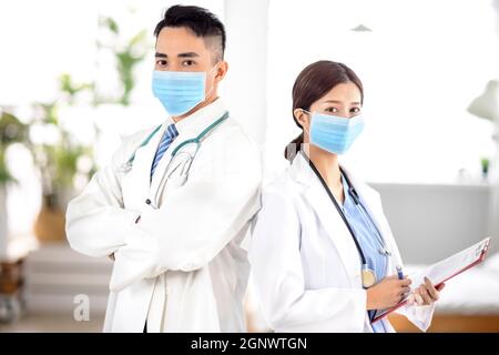 two doctors faces wearing protective mask in Hospital Stock Photo