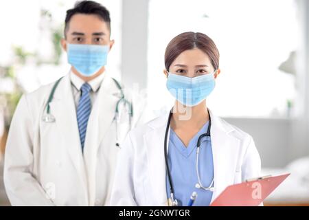 two doctors faces wearing protective mask in Hospital Stock Photo