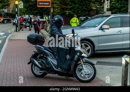 London, UK. 28th Sep, 2021. A scooter rider jumps the queue by coming in the the exit - Fuel shortages escalate due to panic buying, as Sainsburys near Clapham South is now open again with long queues. The shortage is a result of a lack of tanker drivers due to the extended impact of Brexit on European migrant workers. Credit: Guy Bell/Alamy Live News Stock Photo