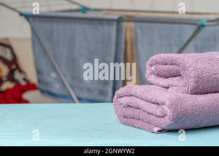 Housework concept. Ironing towels on ironing board Stock Photo
